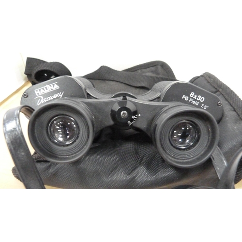27 - Pair of small Celestron 16x32 binoculars, boxed, and a pair of Halina 8x30 binoculars with outer bag... 