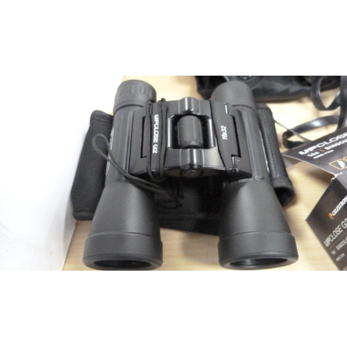 27 - Pair of small Celestron 16x32 binoculars, boxed, and a pair of Halina 8x30 binoculars with outer bag... 