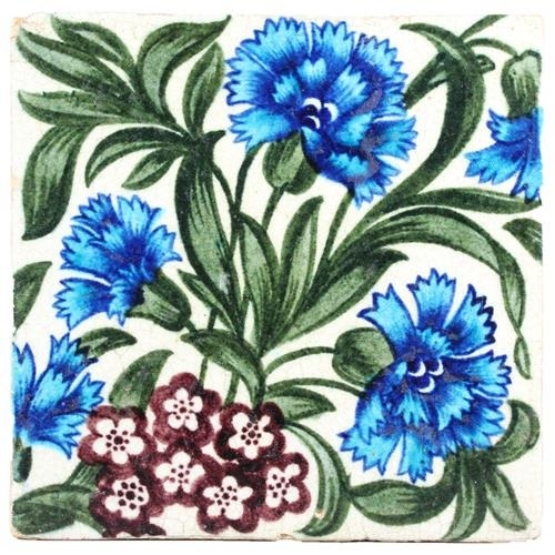 William De Morgan Arts and Crafts ceramic floral tile in blue and green, marked to back 'W De Merton Abbey', 19cm.