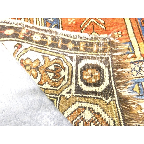 Afghan wool prayer rug having two geometric ghuls against a red, blue ...