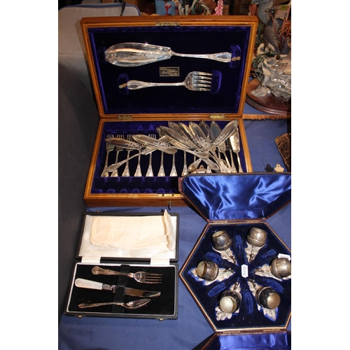110 - Cased set of thistle style condiments, Christening set and a canteen of fish cutlery.