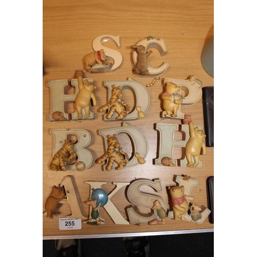 255 - Twelve Winnie the Pooh themed figural letter ornaments, c.8cm tall and a Danbury Mint Little Bronze ... 