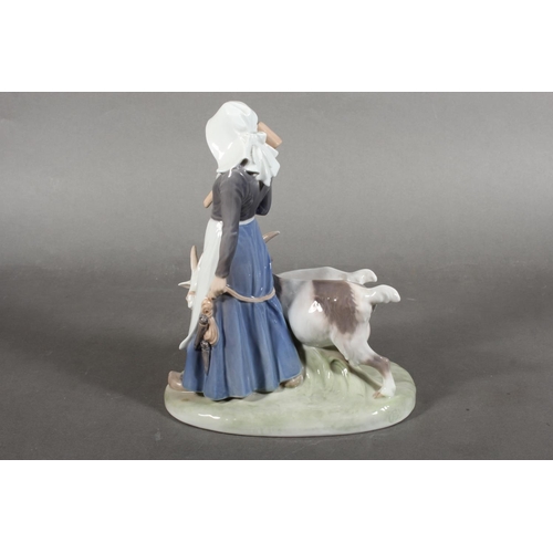 300 - Royal Copenhagen porcelain figure group of a lady with two goats, number 694, 23cm tall.
