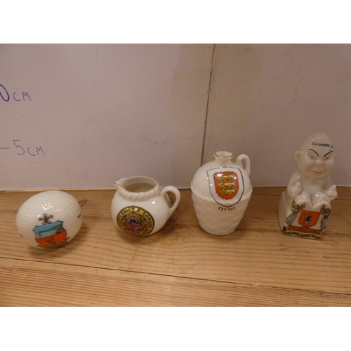 130 - Collection of crested ware ornaments to include cups, longcase clock, animals, vehicles etc.