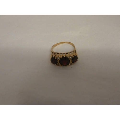 180 - 9ct gold garnet three-stone ring, '375', size S, 3.6g gross.