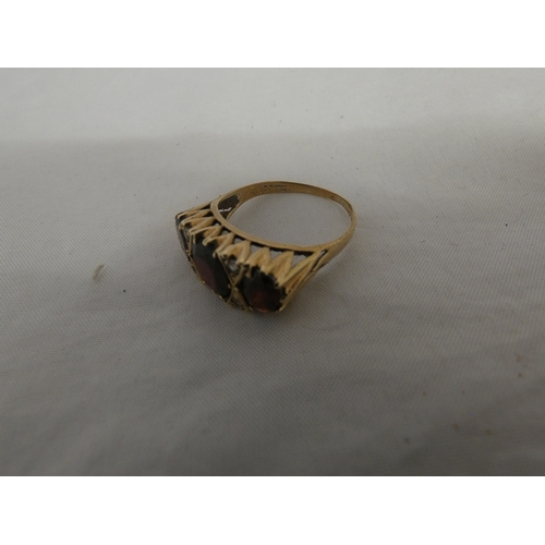 180 - 9ct gold garnet three-stone ring, '375', size S, 3.6g gross.