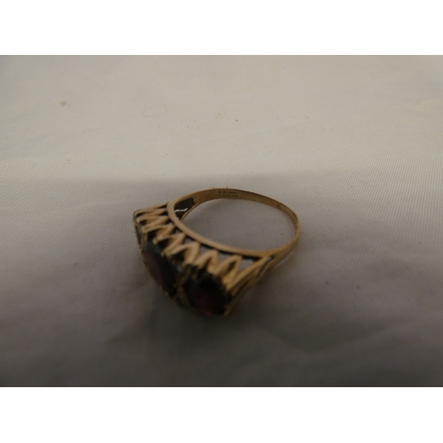 180 - 9ct gold garnet three-stone ring, '375', size S, 3.6g gross.