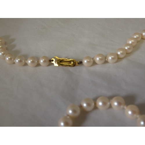 182 - String of synthetic pearls with 9ct gold snap, in fitted box by Lotus de Luxe.