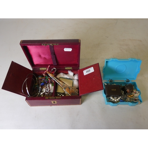 202 - Collection of decorative jewellery and badges to include military-themed badges and buttons, British... 