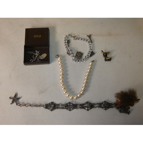 202 - Collection of decorative jewellery and badges to include military-themed badges and buttons, British... 