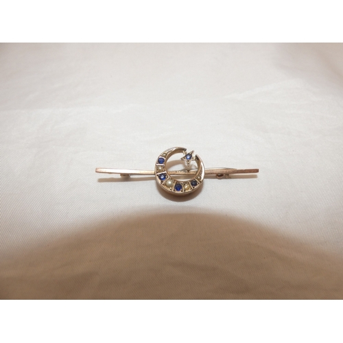 214 - Late Victorian sapphire and seed pearl crescent brooch on unmarked yellow metal.