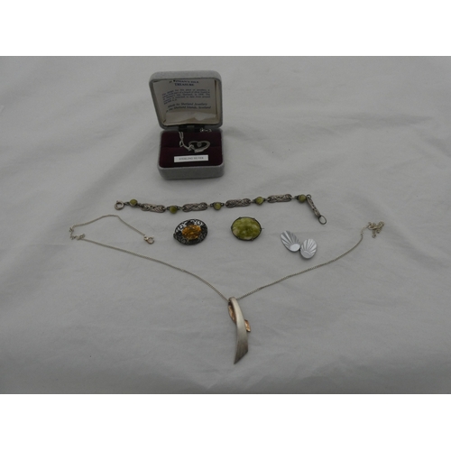 217 - Group of silver jewellery to include a pendant on chain, chain, and a brooch.