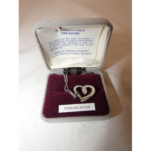 217 - Group of silver jewellery to include a pendant on chain, chain, and a brooch.