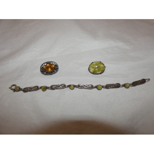 217 - Group of silver jewellery to include a pendant on chain, chain, and a brooch.