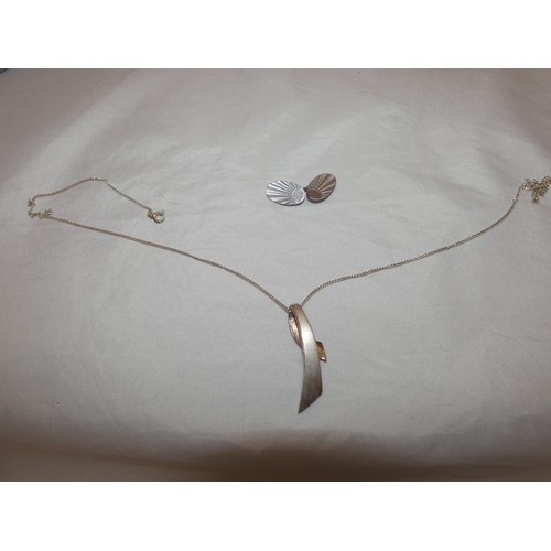 217 - Group of silver jewellery to include a pendant on chain, chain, and a brooch.