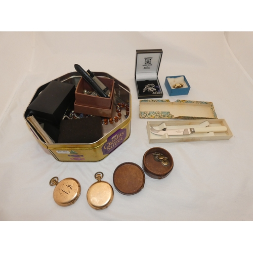 218 - Tin containing watches, jewellery and curios to include two rolled gold full hunter pocket watches, ... 