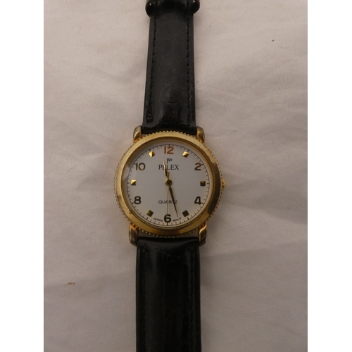 218 - Tin containing watches, jewellery and curios to include two rolled gold full hunter pocket watches, ... 