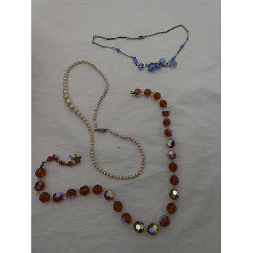 218 - Tin containing watches, jewellery and curios to include two rolled gold full hunter pocket watches, ... 