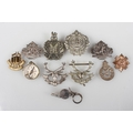 Group of military cap badges, etc and compass and whistle.
