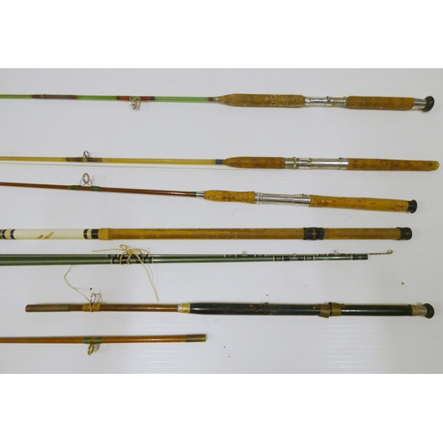 Nine assorted fishing rods, mainly sea fishing examples.
