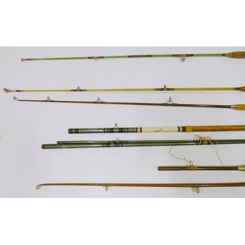 Nine assorted fishing rods, mainly sea fishing examples.