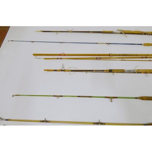 Nine assorted fishing rods, mainly sea fishing examples.