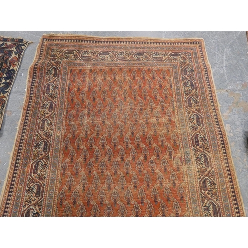 186 - Persian hand-knotted tribal rug and a Persian Sarouk rug (both have tears and wear).&nbsp; (2)