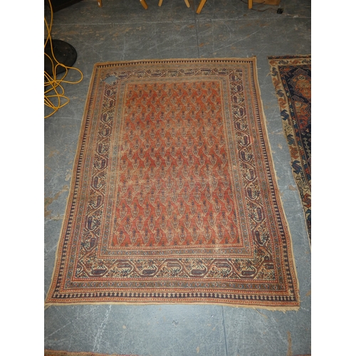 186 - Persian hand-knotted tribal rug and a Persian Sarouk rug (both have tears and wear).&nbsp; (2)