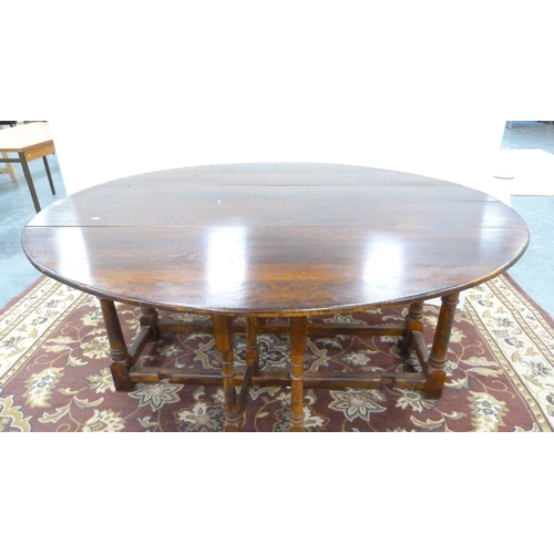198 - Large oak gate-leg dining table.