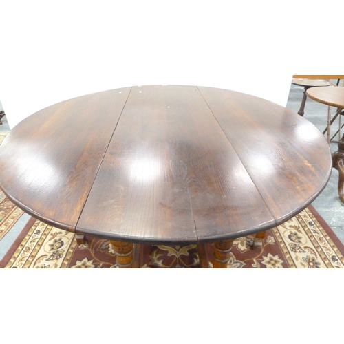 198 - Large oak gate-leg dining table.