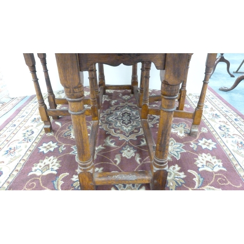198 - Large oak gate-leg dining table.