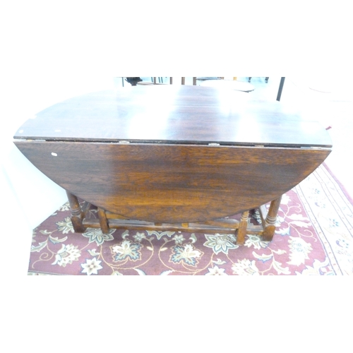 198 - Large oak gate-leg dining table.