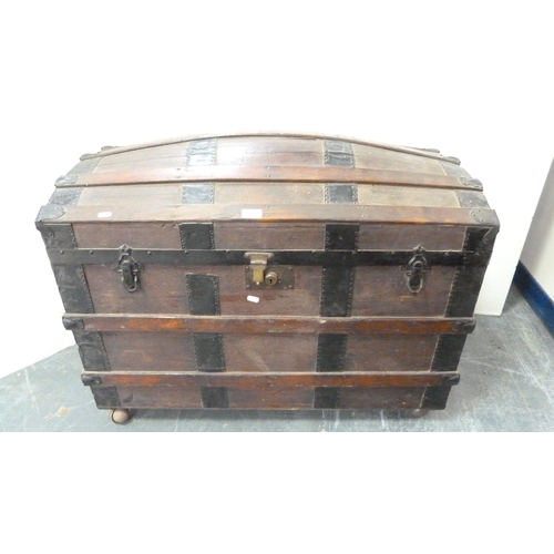 217 - Wood-bound domed travel trunk.