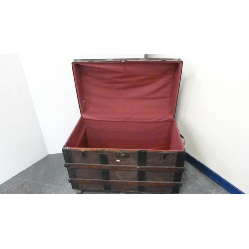 217 - Wood-bound domed travel trunk.