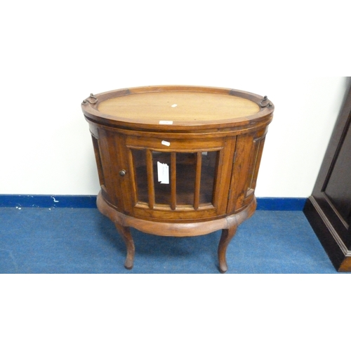 226 - Indonesian reproduction oval drinks cabinet with serving tray top.