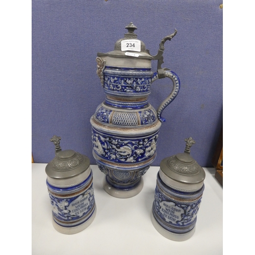 234 - Large German salt glazed jug with pewter cover and two steins.