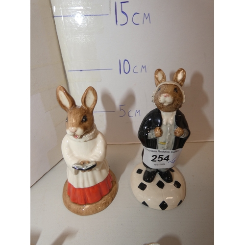 254 - Two Royal Doulton Bunnykins figures to include 'Lawyer Bunnykins', and two Continental Meissen-style... 