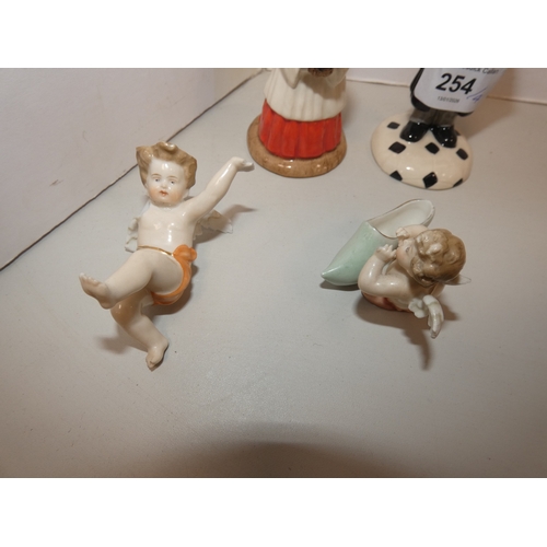 254 - Two Royal Doulton Bunnykins figures to include 'Lawyer Bunnykins', and two Continental Meissen-style... 