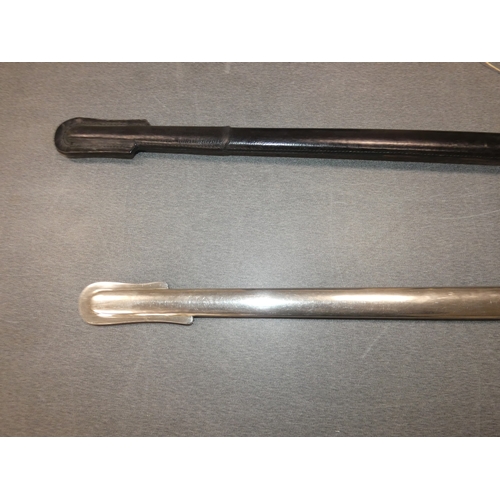 265 - Two sword scabbards, one tooled, the other metal.&nbsp; (2)