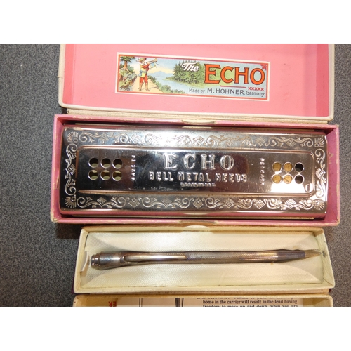 269 - Two Hohner 'The Echo Harp' harmonicas, in fitted boxes, and a boxed sterling silver propelling penci... 