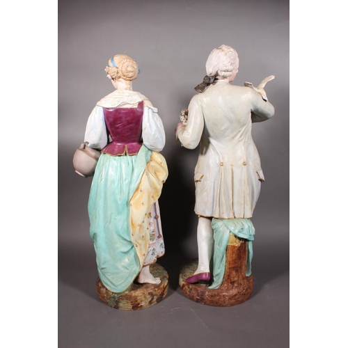 211 - Large pair of 19th century porcelain figures, the male modelled holding a pair of doves, the female ... 