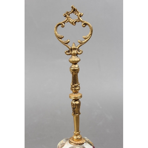 203 - Italian Capodimonte table bell decorated in relief with chariot scene, gilded brass handle, 31cm tal... 