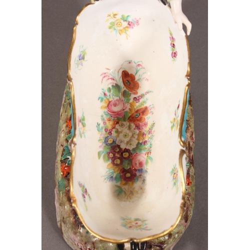 213 - Continental novelty porcelain cream boat in the form of a female flower seller pushing a three wheel... 
