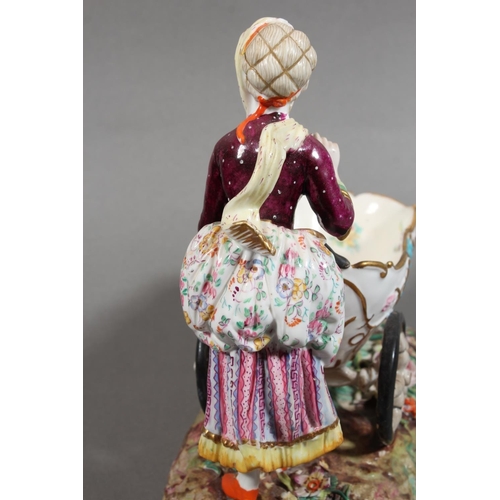 213 - Continental novelty porcelain cream boat in the form of a female flower seller pushing a three wheel... 