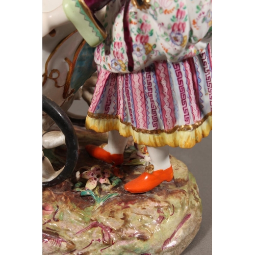 213 - Continental novelty porcelain cream boat in the form of a female flower seller pushing a three wheel... 