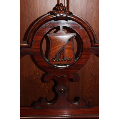 463 - Late Victorian carved mahogany bench, the back with family crest shield plaque depicting a hand clut... 