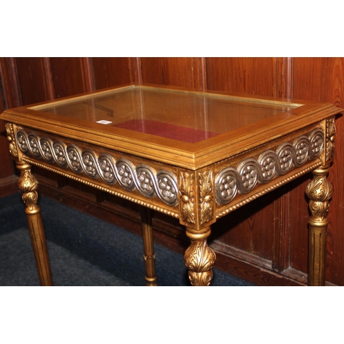 465 - Modern gold and silver effect hinge top bijouterie table, raised on turned and fluted supports termi... 