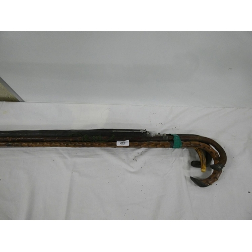 283 - Three antique walking sticks and umbrella.
