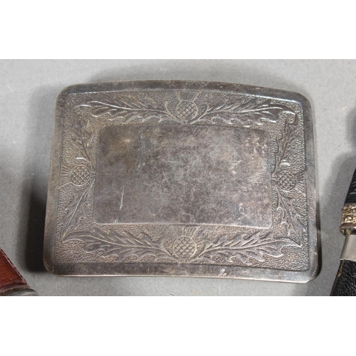 10 - Two sgian dubhs, a silver-plated and leather hip flask and a Scottish silver-plated belt plate.