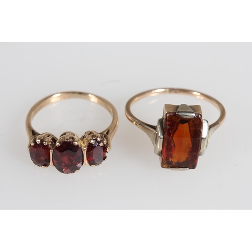 478 - 9ct yellow gold garnet three stone set ring and another, 4.7g.